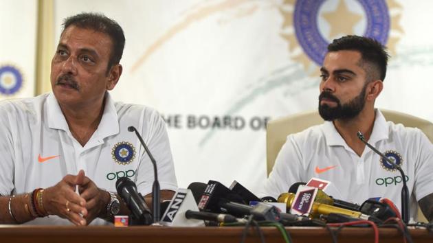 Ravi Shastri (L) speaks during a press conference as cricket team captain Virat Kohli (R) looks on.(AFP)