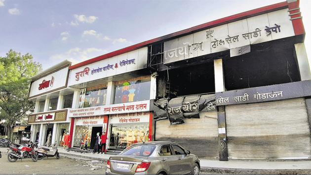 Saree shops line up the Uruli Devachi village. On the left is the shop which was gutted on May 9.(RAHUL RAUT/HT PHOTO)