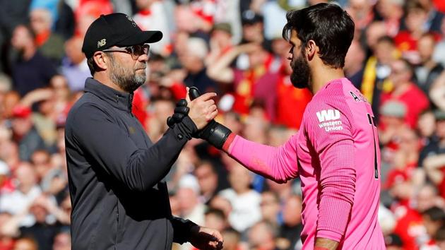 Liverpool manager Juergen Klopp shakes hands with Alisson after the match.(REUTERS)