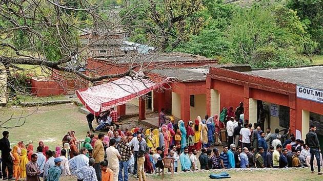 People wait outside a polling station at Udhampur, about 75 km from Jammu, on April 18. Jammu and Kashmir voted in five phases in the seven-phased general elections.(Nitin Kanotra /HT PHOTO)