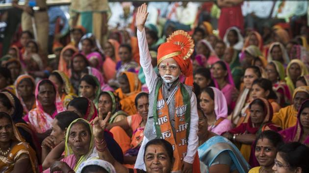 The election rallies witnessed supporters attired in the colours of their favourite political party/leader and often in elaborate costumes. In one such rally addressed by Prime Minister Narendra Modi in Maharashtra’s Nandurbar district, Priyanshu Machhale (C) was seen dressed up just like the PM. In his 51-day-long election campaign, PM Modi addressed 142 rallies. (Pratik Chorge / HT Photo) 