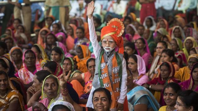 The election rallies witnessed supporters attired in the colours of their favourite political party/leader and often in elaborate costumes. In one such rally addressed by Prime Minister Narendra Modi in Maharashtra’s Nandurbar district, Priyanshu Machhale (C) was seen dressed up just like the PM. In his 51-day-long election campaign, PM Modi addressed 142 rallies. (Pratik Chorge / HT Photo) The election rallies witnessed supporters attired in the colours of their favourite political party/leader and often in elaborate costumes. In one such rally addressed by Prime Minister Narendra Modi in Maharashtra’s Nandurbar district, Priyanshu Machhale (C) was seen dressed up just like the PM. In his 51-day-long election campaign, PM Modi addressed 142 rallies. (Pratik Chorge / HT Photo)