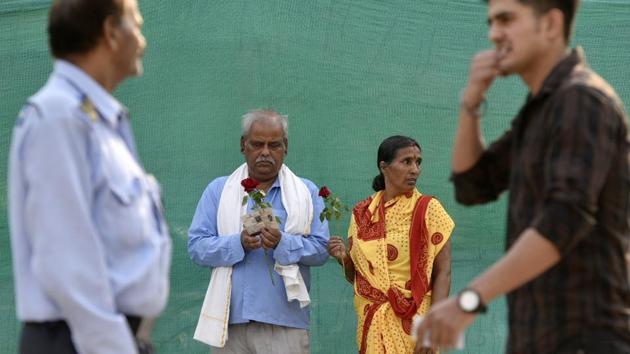 At some polling booths in Delhi, people were given red roses after exercising their franchise. Narayan Yadav and his wife Ramday Yadav are seen with a couple of such roses outside a polling booth at Krishna Nagar. (Biplov Bhuyan / HT Photo) 