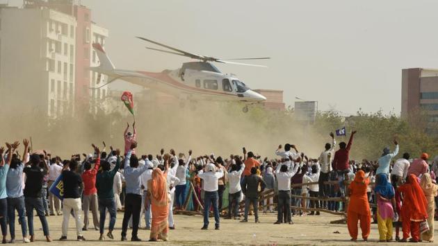 Three days before the elections kicked off on April 11, supporters of Bahujan Samaj Party (BSP) were elated at the sight of a helicopter carrying party supremo Mayawati arriving for an election rally in Greater Noida, Uttar Pradesh. While Mayawati herself did not contest the elections this time, she did address a number of public rallies in support of her party’s candidates. (Virendra Singh Gosain / HT Photo) 