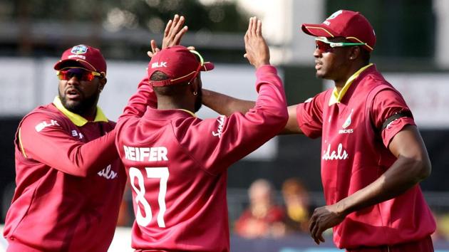 West Indies' captain Jason Holder (R) celebrates with teammates after taking the wicket of Bangladesh's Tamim Iqbal.(AFP)