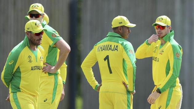 Australia's David Warner, Usman Khawaja and Steve Smith, from left, gather during the Cricket World Cup warm-up.(AP)