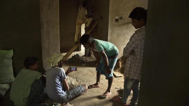 Labourers at a building construction site watch election trends on a mobile phone in Guwahati. The BJP is currently ahead in nine of 14 Lok Sabha seats in Assam, while its ally Asom Gana Parishad is leading in two seats, according to the Election Commission. The saffron party has conceded three seats to its allies this time - two to the AGP and one to the Bodoland People’s Front (BPF). (Anupam Nath / AP) Labourers at a building construction site watch election trends on a mobile phone in Guwahati. The BJP is currently ahead in nine of 14 Lok Sabha seats in Assam, while its ally Asom Gana Parishad is leading in two seats, according to the Election Commission. The saffron party has conceded three seats to its allies this time - two to the AGP and one to the Bodoland People’s Front (BPF). (Anupam Nath / AP)
