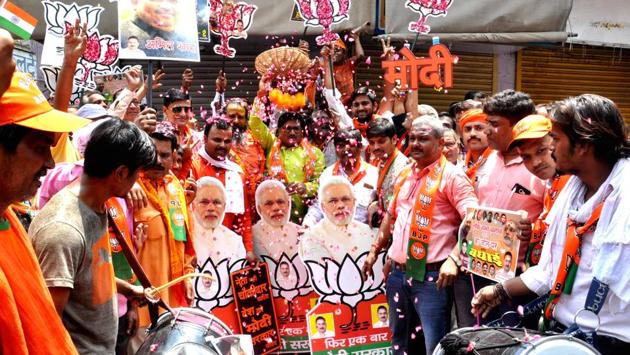 BJP supporters celebrate trends in Varanasi. Prime Minister Narendra Modi is leading by over 400,000 votes against his SP rival. The BJP-led NDA was ahead on 58 seats in trends for the the Lok Sabha election on Thursday with the SP-BSP combine at 19 seats, in the politically crucial state of Uttar Pradesh that send 80 lawmakers to Lok Sabha. (Rajesh Kumar / HT Photo) BJP supporters celebrate trends in Varanasi. Prime Minister Narendra Modi is leading by over 400,000 votes against his SP rival. The BJP-led NDA was ahead on 58 seats in trends for the the Lok Sabha election on Thursday with the SP-BSP combine at 19 seats, in the politically crucial state of Uttar Pradesh that send 80 lawmakers to Lok Sabha. (Rajesh Kumar / HT Photo)