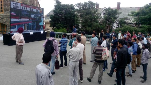 People watch election results at Mall Road in Shimla. The ruling BJP is surging ahead in all four Lok Sabha seats of Himachal Pradesh, with its candidates securing unassailable leads, according to latest Election Commission trends. In Mandi, the sitting BJP MP Ram Swaroop is leading by over 154418 votes over his nearest rival Aashray Sharma of the Congress. (ANI) People watch election results at Mall Road in Shimla. The ruling BJP is surging ahead in all four Lok Sabha seats of Himachal Pradesh, with its candidates securing unassailable leads, according to latest Election Commission trends. In Mandi, the sitting BJP MP Ram Swaroop is leading by over 154418 votes over his nearest rival Aashray Sharma of the Congress. (ANI)