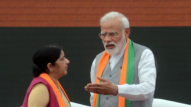 Prime Minister Narendra Modi in a conversation with Sushma Swaraj during the release of Sankalp Patra.(ANI)