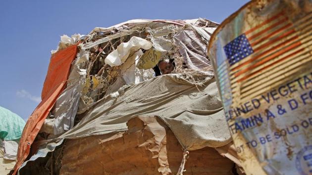 A Somali boy displaced by drought peers out from a makeshift shelter at a camp for displaced persons in the Daynile neighbourhood on the outskirts of the capital Mogadishu, in Somalia. The UN’s Food and Agriculture Organization this week issued a warning projecting some 2.2 million people in Somalia face “severe hunger” in the coming months. (Farah Abdi Warsameh / AP)