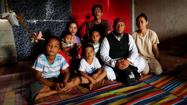 Mohammad Ali Acampong, 42, poses for a portrait with his family in a school-turned-evacuation centre at Mipaga in Marawi. During the conflict, Acampong left his three-storey lakeside house with his family of eight.”When the chaos began, our life suddenly became really difficult. We had a comfortable life before. Now we live in between shelters, enduring heat, the lack of water, the lack of everything,” he said. (Eloisa Lopez / REUTERS) Mohammad Ali Acampong, 42, poses for a portrait with his family in a school-turned-evacuation centre at Mipaga in Marawi. During the conflict, Acampong left his three-storey lakeside house with his family of eight.”When the chaos began, our life suddenly became really difficult. We had a comfortable life before. Now we live in between shelters, enduring heat, the lack of water, the lack of everything,” he said. (Eloisa Lopez / REUTERS)