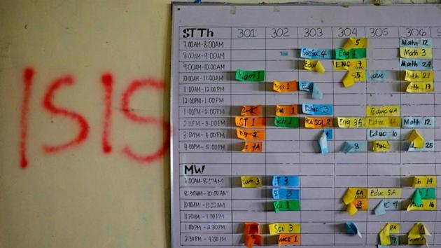 A class schedule is seen on a wall spray-painted with “ISIS” at a school in the most affected war-torn area of Marawi. Hundreds of militants, 165 soldiers and at least 45 civilians were killed in the five-month conflict. President Rodrigo Duterte in October 2017 declared the city liberated, and its rehabilitation officially underway. But there is little sign of progress. (Eloisa Lopez / REUTERS) A class schedule is seen on a wall spray-painted with “ISIS” at a school in the most affected war-torn area of Marawi. Hundreds of militants, 165 soldiers and at least 45 civilians were killed in the five-month conflict. President Rodrigo Duterte in October 2017 declared the city liberated, and its rehabilitation officially underway. But there is little sign of progress. (Eloisa Lopez / REUTERS)