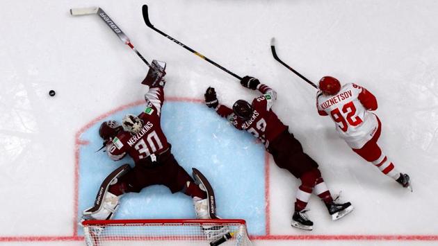 Latvia’s Elvis Merzlikins and Teodors Blugers and Russia’s Yevgeny Kuznetsov in action during the Group B Latvia v Russia Ice Hockey World Championships match at Ondrej Nepela Arena in Bratislava, Slovakia. (Vasily Fedosenko / REUTERS)