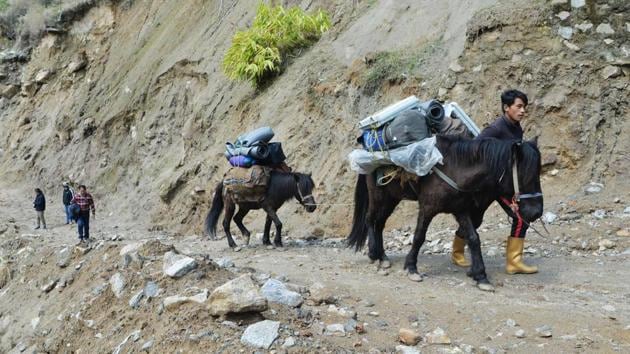 Polling workers trek to transport Electronic Voting Machines (EVM) and Voter-Verified Paper Audit Trail (VVPAT) machines to a remote polling station –one of a million organised –in Srikhola at an altitude of 2,800 metres above sea level near the India-Nepal border in West Bengal. From cities and villages to remote islands and dense jungles, the 2019 polls saw polling last seven phases spread over 39 days. (Diptendu Dutta / AFP) Polling workers trek to transport Electronic Voting Machines (EVM) and Voter-Verified Paper Audit Trail (VVPAT) machines to a remote polling station –one of a million organised –in Srikhola at an altitude of 2,800 metres above sea level near the India-Nepal border in West Bengal. From cities and villages to remote islands and dense jungles, the 2019 polls saw polling last seven phases spread over 39 days. (Diptendu Dutta / AFP)