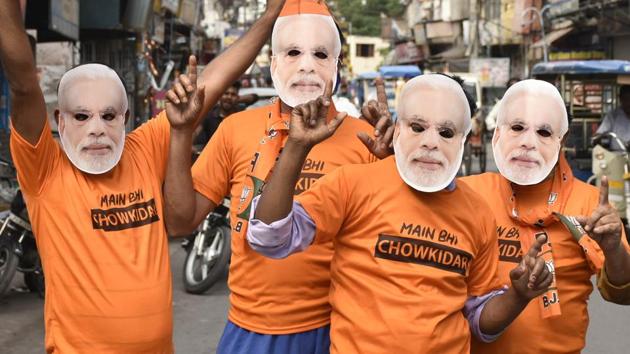 Bharatiya Janata Party (BJP) workers seen wearing Prime Minister Narendra Modi masks and ‘Chowkidaar’ T-shirts as National Democratic Alliance (NDA) takes lead in the Lok Sabha election results, in Amritsar, Punjab, India, on Thursday, May 23, 2019.(Sameer Sehgal/ Hindustan Times)