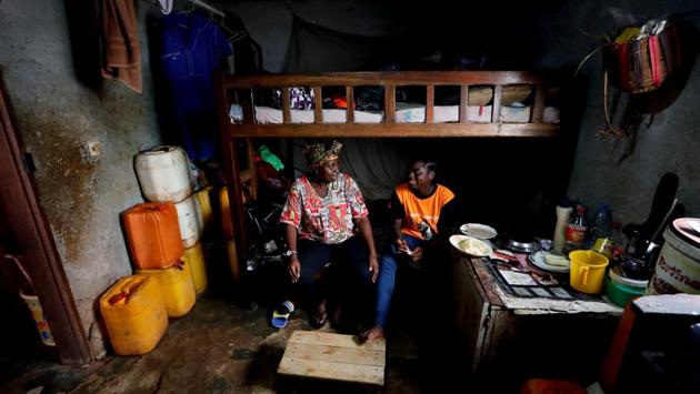 Gaelle Dule Asheri eats and talks to her mother Fouda Marie-Bernadette as she sits on her bed in Yaounde. Asheri never gave up her dream despite strong opposition from her mother who feared she would lose her daughter to a “men’s game”. (Zohra Bensemra / REUTERS) Gaelle Dule Asheri eats and talks to her mother Fouda Marie-Bernadette as she sits on her bed in Yaounde. Asheri never gave up her dream despite strong opposition from her mother who feared she would lose her daughter to a “men’s game”. (Zohra Bensemra / REUTERS)