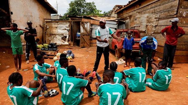 The academy currently trains around 70 girls, most of whom come from poor backgrounds and would otherwise not be able to afford even their own soccer boots, said coach Emmanuel Biolo (C). “Here they have everything: coaches, jerseys, training equipment, a physiotherapist, and the guidance we give them all the time. Gaelle Enganamouit really wants these kids to be the next generation,” he said. (Zohra Bensemra / REUTERS) The academy currently trains around 70 girls, most of whom come from poor backgrounds and would otherwise not be able to afford even their own soccer boots, said coach Emmanuel Biolo (C). “Here they have everything: coaches, jerseys, training equipment, a physiotherapist, and the guidance we give them all the time. Gaelle Enganamouit really wants these kids to be the next generation,” he said. (Zohra Bensemra / REUTERS)