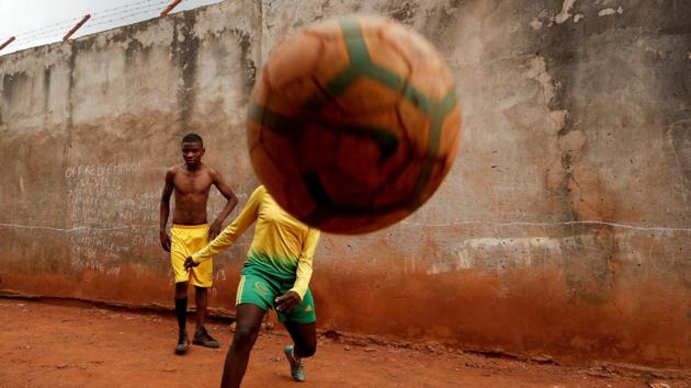 Gaelle Dule Asheri, plays football with her friends outside her house in Yaounde, Cameroon. When Asheri first started playing soccer in the dirt streets near her home in Cameroon’s capital, she was the only girl on the informal neighbourhood teams which used stones for goal posts and kept score by chalking results on a wall. (Zohra Bensemra / REUTERS)