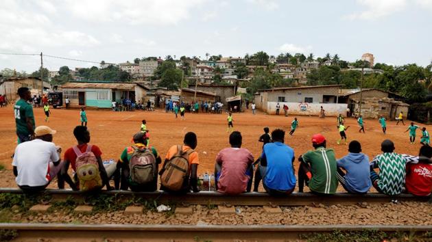 People sit on train tracks as they watch a friendly match between U15, a boys team and U17, a team of first wave of girls being trained by the Rails Foot Academy. The academy gets its name from the train tracks that hem the playing ground and turn into informal stands for the local spectators, who gather to watch the girls’ teams play all-male sides. (Zohra Bensemra / REUTERS) People sit on train tracks as they watch a friendly match between U15, a boys team and U17, a team of first wave of girls being trained by the Rails Foot Academy. The academy gets its name from the train tracks that hem the playing ground and turn into informal stands for the local spectators, who gather to watch the girls’ teams play all-male sides. (Zohra Bensemra / REUTERS)