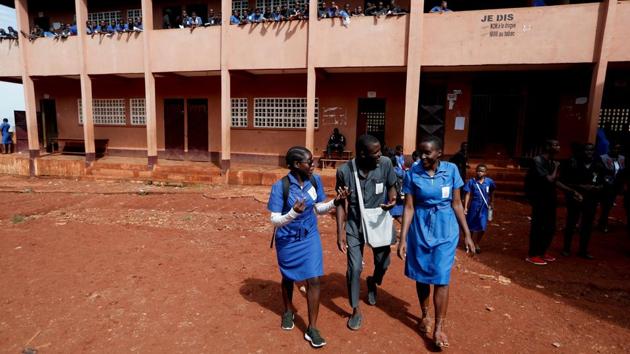 Gaelle Dule Asheri (L), walks with her classmates at a bilingual high school where she prepares for her final baccalaureate exams. Asheri attends the academy on Saturday mornings and after school on Wednesdays, changing out of her uniform - a belted blue knee-length dress - into her team’s matching kit. She is studying, but the dream for her and Pouadjeu is to play soccer at a professional level. (Zohra Bensemra / REUTERS) Gaelle Dule Asheri (L), walks with her classmates at a bilingual high school where she prepares for her final baccalaureate exams. Asheri attends the academy on Saturday mornings and after school on Wednesdays, changing out of her uniform - a belted blue knee-length dress - into her team’s matching kit. She is studying, but the dream for her and Pouadjeu is to play soccer at a professional level. (Zohra Bensemra / REUTERS)