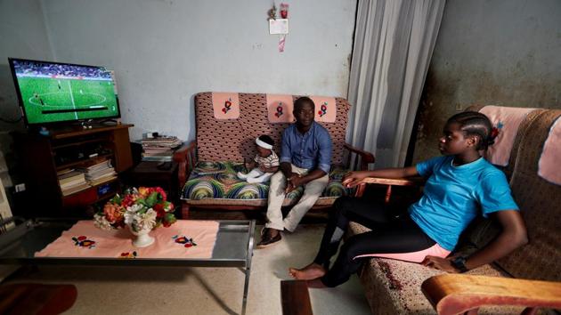 Gaelle Dule Asheri watches TV with her father Emmanuel in their sitting room in Yaounde. Global interest in women’s soccer is growing and FIFA hopes over a billion viewers will tune in to watch the Women’s World Cup in June. Cameroon’s national side, known as the Indomitable Lionesses, was one of three African teams to qualify. (Zohra Bensemra / REUTERS) Gaelle Dule Asheri watches TV with her father Emmanuel in their sitting room in Yaounde. Global interest in women’s soccer is growing and FIFA hopes over a billion viewers will tune in to watch the Women’s World Cup in June. Cameroon’s national side, known as the Indomitable Lionesses, was one of three African teams to qualify. (Zohra Bensemra / REUTERS)