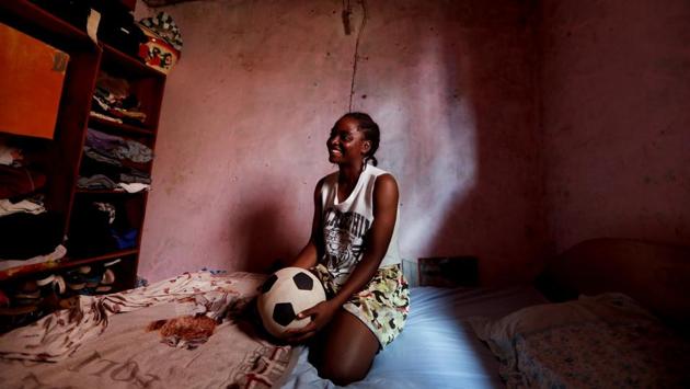 Ida Daniela Pouadjeu, smiles as she sits on her bed. Pouadjeu is angry about people’s attitude towards female soccer players. An orphan, she was brought up by her aunt who once warned her against playing football saying she would end up sleeping with all the girls at the academy. Pouadjeu says she uses that anger every day on the pitch. “I train hard to succeed and to prove them all wrong,” she said. (Zohra Bensemra / REUTERS) Ida Daniela Pouadjeu, smiles as she sits on her bed. Pouadjeu is angry about people’s attitude towards female soccer players. An orphan, she was brought up by her aunt who once warned her against playing football saying she would end up sleeping with all the girls at the academy. Pouadjeu says she uses that anger every day on the pitch. “I train hard to succeed and to prove them all wrong,” she said. (Zohra Bensemra / REUTERS)