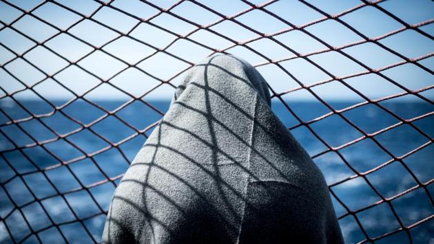 A migrant looks out at the water, onboard the Sea Watch 3 German charity ship, off the coast of Lampedusa, Italy. (Nick Jaussi / Sea-Watch via REUTERS)