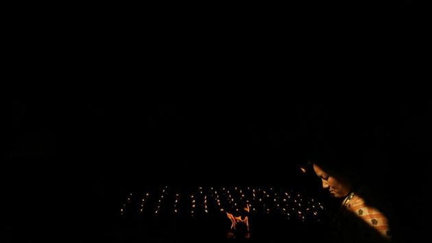 A Nepalese Buddhist woman lights a butter lamp during Buddha Jayanti, or Buddha Purnima, festival in Kathmandu, Nepal. The festival marks the triple events of Gautam Buddha’s life: his birth, his enlightenment and his attaining a state of Nirvana that frees believers from the circle of death and rebirth. (Niranjan Shrestha / AP)