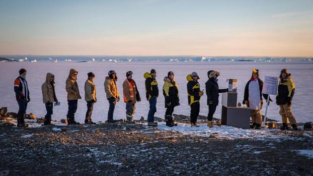 Australian researchers queue up to cast their votes at a special polling station at Davis research station, Antarctica. Australians flocked to the polls on May 18 capping a bitterly fought election that may be the first anywhere decided by climate policy. (Greg Stone / Australian Antarctic Division / AFP)