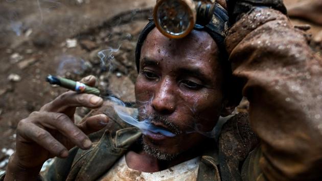 A miner resting as he smokes a cigar at a ruby mine in Mogok, north of Mandalay, Myanmar. Burrowing deep underground, thousands of informal miners risk their lives to find gleaming red gems as a law change spurs opportunity in Myanmar's “land of rubies”. (Ye Aung Thu / AFP)