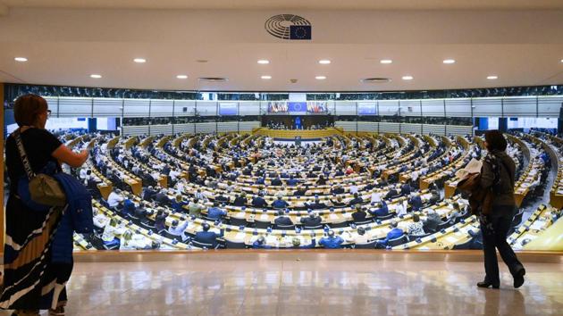 Visitors walk past a giant images of the European Parliament hemicycle at the European Parliament museum in Brussels on May 24, 2019. (Photo by EMMANUEL DUNAND / AFP) (AFP) Visitors walk past a giant images of the European Parliament hemicycle at the European Parliament museum in Brussels on May 24, 2019. (Photo by EMMANUEL DUNAND / AFP) (AFP)