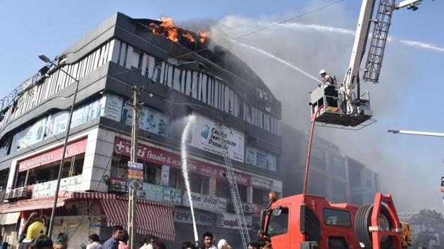 An FIR has been registered under IPC sections 304 and 308 after At least 20 students died and 20 were injured when a commercial complex in Surat’s Sarthana neighbourhood caught fire on Friday. The FIR named three persons including two builders and a director of smart design studio Bhargav Butani. The police have arrested Butani this morning. (HT Photo) An FIR has been registered under IPC sections 304 and 308 after At least 20 students died and 20 were injured when a commercial complex in Surat’s Sarthana neighbourhood caught fire on Friday. The FIR named three persons including two builders and a director of smart design studio Bhargav Butani. The police have arrested Butani this morning. (HT Photo)