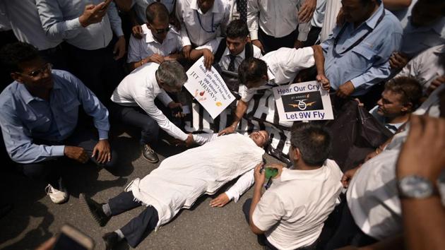 A Jet Airways employee feigns death during a protest against delayed salaries and the current shutdown crisis outside Rajiv Gandhi bhawan at Jor Bagh in New Delhi. (Biplov Bhuyan / HT Photo) A Jet Airways employee feigns death during a protest against delayed salaries and the current shutdown crisis outside Rajiv Gandhi bhawan at Jor Bagh in New Delhi. (Biplov Bhuyan / HT Photo)