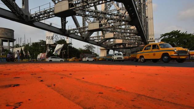 A road is left smeared with saffron colour by celebrations from Bharatiya Janata Party (BJP) supporters with massive leads projected in the Lok Sabha election results, near Howrah Bridge, in Howrah, West Bengal. (Arijit Sen / HT Photo) A road is left smeared with saffron colour by celebrations from Bharatiya Janata Party (BJP) supporters with massive leads projected in the Lok Sabha election results, near Howrah Bridge, in Howrah, West Bengal. (Arijit Sen / HT Photo)