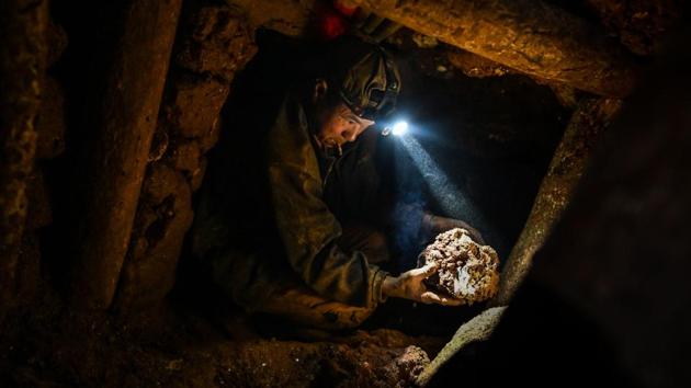 “Sometimes you hit another tunnel when you’re digging underground,” one miner, asking not to be named, covered in mud and kitted out with head torch and walkie-talkie. Tunnel collapses are a constant threat in this scramble for riches, and the start of the rainy season only ups the risk. (Ye Aung Thu / AFP)