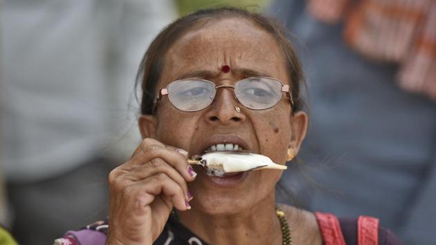 An elderly woman eats an ice cream on a hot summer day at India Gate, in New Delhi. (Burhaan Kinu / HT Photo) An elderly woman eats an ice cream on a hot summer day at India Gate, in New Delhi. (Burhaan Kinu / HT Photo)