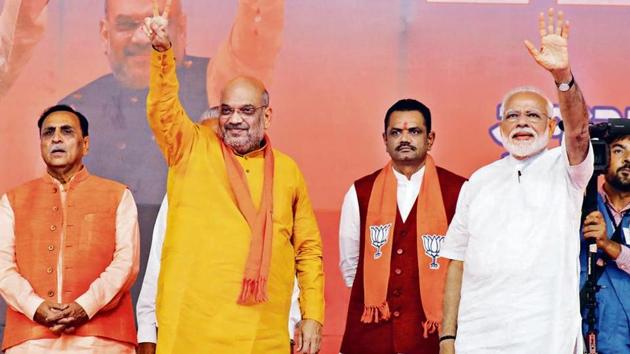 Prime Minister of India Narendra Modi (R) and Bharatiya Janata Party (BJP) president Amit Shah wave at supporters during a public meeting, in Ahmedabad, Gujarat, on May 26, 2019. (Siddharaj Solanki / Hindustan Times)