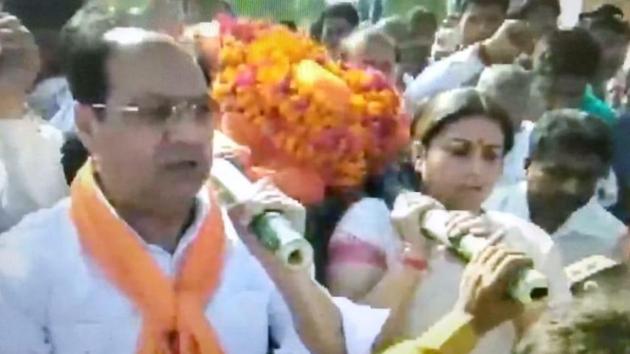 A video grab showing Amethi MP Smriti Irani shouldering the mortal remains of the BJP worker shot dead on Saturday night.