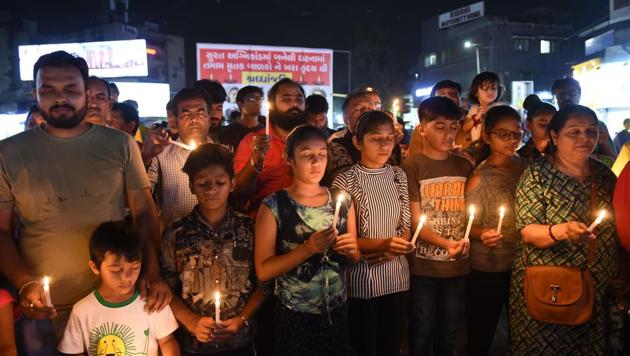 Members of a Narendra Modi fan club hold a candlelight vigil to pay homage to the victims of yesterday's fire in a building housing a college in Surat, in Ahmedabad on May 25, 2019.(AFP File Photo)