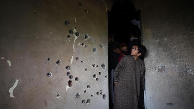 A boy looks at a bullet-riddled wall of a residential house that was damaged during a gun battle between militant commander Zakir Musa and security forces, at Dadasara village, in Tral, Jammu and Kashmir. (Waseem Andrabi / HT Photo) A boy looks at a bullet-riddled wall of a residential house that was damaged during a gun battle between militant commander Zakir Musa and security forces, at Dadasara village, in Tral, Jammu and Kashmir. (Waseem Andrabi / HT Photo)