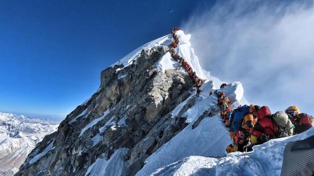 In this file handout photo taken on May 22, 2019 and released by climber Nirmal Purja's Project Possible expedition shows heavy traffic of mountain climbers lining up to stand at the summit of Mount Everest. - Three more climbers have died on Everest, expedition organisers and officials said on May 24, taking the toll from a deadly week on the overcrowded world's highest peak to seven. (AFP photo) In this file handout photo taken on May 22, 2019 and released by climber Nirmal Purja's Project Possible expedition shows heavy traffic of mountain climbers lining up to stand at the summit of Mount Everest. - Three more climbers have died on Everest, expedition organisers and officials said on May 24, taking the toll from a deadly week on the overcrowded world's highest peak to seven. (AFP photo)