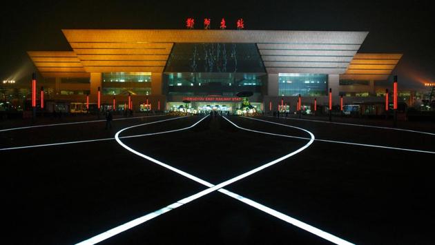 LED lights illuminate the pavement square in front of a high speed railway station in the new business district of Zhengzhou, Henan province. Long a quiet provincial capital, Zhengzhou has thrived in recent years thanks to its position as a transport and logistics hub. Taiwan’s Foxconn operates a factory in the city employing 230,000 people making Apple iPhones for the world. (Thomas Peter / REUTERS) LED lights illuminate the pavement square in front of a high speed railway station in the new business district of Zhengzhou, Henan province. Long a quiet provincial capital, Zhengzhou has thrived in recent years thanks to its position as a transport and logistics hub. Taiwan’s Foxconn operates a factory in the city employing 230,000 people making Apple iPhones for the world. (Thomas Peter / REUTERS)