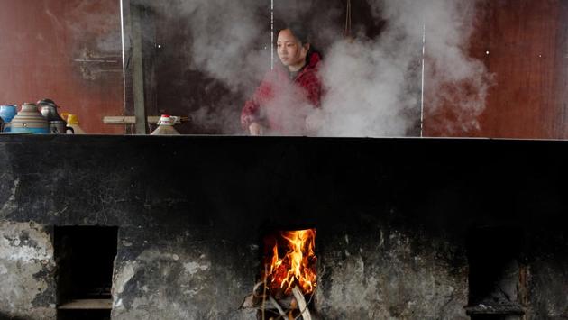Jiejie Li prepares food on a wood stove in a makeshift dwelling at the Yellow River embankment on the northern outskirts of Zhengzhou. The city’s property market exploded when the Chinese government eased borrowing and credit restrictions in 2015 and 2016, setting off a nationwide home-buying frenzy. (Thomas Peter / REUTERS) Jiejie Li prepares food on a wood stove in a makeshift dwelling at the Yellow River embankment on the northern outskirts of Zhengzhou. The city’s property market exploded when the Chinese government eased borrowing and credit restrictions in 2015 and 2016, setting off a nationwide home-buying frenzy. (Thomas Peter / REUTERS)
