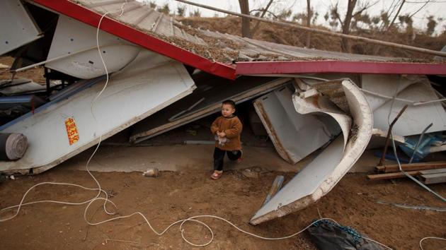 The son of 32-year-old fisherman Sun Lianxi walks among the debris of their former housing. As part of a broad-ranging environmental crackdown, local authorities in 2017 took over the houseboat in the name of minimising water pollution and overfishing. The Suns now live in tents of tarpaulin and plastic sheets by a floating bridge on the banks of the Yellow River, reduced to fishing from a small dinghy. (Thomas Peter / REUTERS) The son of 32-year-old fisherman Sun Lianxi walks among the debris of their former housing. As part of a broad-ranging environmental crackdown, local authorities in 2017 took over the houseboat in the name of minimising water pollution and overfishing. The Suns now live in tents of tarpaulin and plastic sheets by a floating bridge on the banks of the Yellow River, reduced to fishing from a small dinghy. (Thomas Peter / REUTERS)