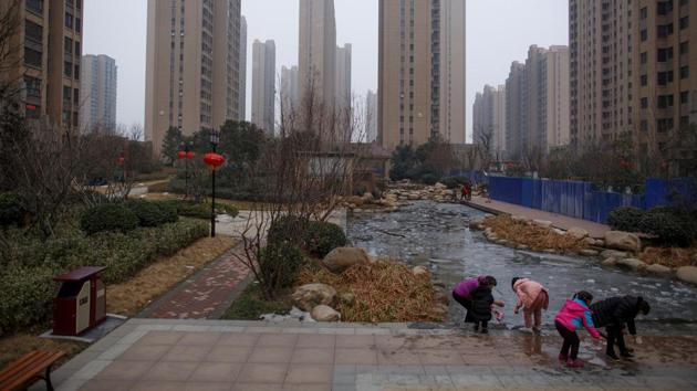 People play with ice floating at a pond in the compound of an apartment complex. After two years of breakneck growth, property markets in provincial cities like Zhengzhou finally reached a turning point in late 2018. That has presented a policy challenge for the Chinese government, which has been attempting to spread wealth beyond the country’s rich coastal regions to the interior. (Thomas Peter / REUTERS) People play with ice floating at a pond in the compound of an apartment complex. After two years of breakneck growth, property markets in provincial cities like Zhengzhou finally reached a turning point in late 2018. That has presented a policy challenge for the Chinese government, which has been attempting to spread wealth beyond the country’s rich coastal regions to the interior. (Thomas Peter / REUTERS)