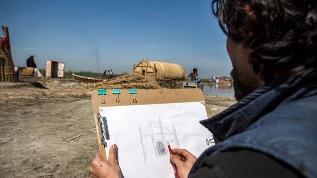 A tourist sketches a drawing of a palm reed-woven house. “Ecotourism has revived the ‘ahwar’. There are Iraqis from different provinces and some foreigners,” Mayali said. A day in the marshes typically involves hiring a resident to paddle a large reed raft down the river for around $25 -- not a cheap fare for Iraq. Then, lunch in a “mudhif” or guesthouse, also run by locals. (Hussein Faleh / AFP) A tourist sketches a drawing of a palm reed-woven house. “Ecotourism has revived the ‘ahwar’. There are Iraqis from different provinces and some foreigners,” Mayali said. A day in the marshes typically involves hiring a resident to paddle a large reed raft down the river for around $25 -- not a cheap fare for Iraq. Then, lunch in a “mudhif” or guesthouse, also run by locals. (Hussein Faleh / AFP)
