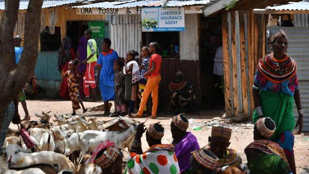 Samburu tribespeople shelter in the shade, adjacent to a livestock insurance agent’s kiosk. The Nairobi-based International Livestock Research Institute uses satellite imagery to determine when pasture levels are critically low. Some insurance products are linked to this index and issue payments before drought hits, so pastoralists can buy fodder for lean times. (Tony Karumba / AFP) Samburu tribespeople shelter in the shade, adjacent to a livestock insurance agent’s kiosk. The Nairobi-based International Livestock Research Institute uses satellite imagery to determine when pasture levels are critically low. Some insurance products are linked to this index and issue payments before drought hits, so pastoralists can buy fodder for lean times. (Tony Karumba / AFP)