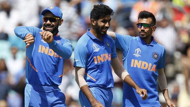 India's Jasprit Bumrah (C) celebrates with India's captain Virat Kohli (L) after taking the wicket of New Zealand's Colin Munro(AFP)