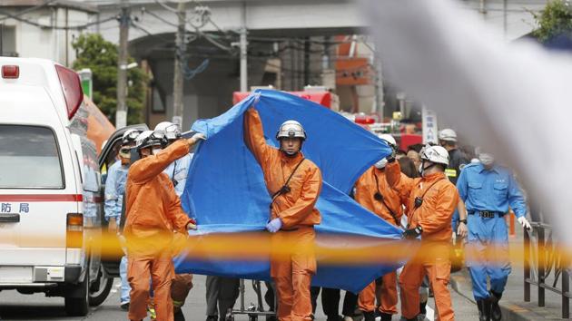 Rescuers work at the scene of an attack in Kawasaki, near Tokyo.(AP)